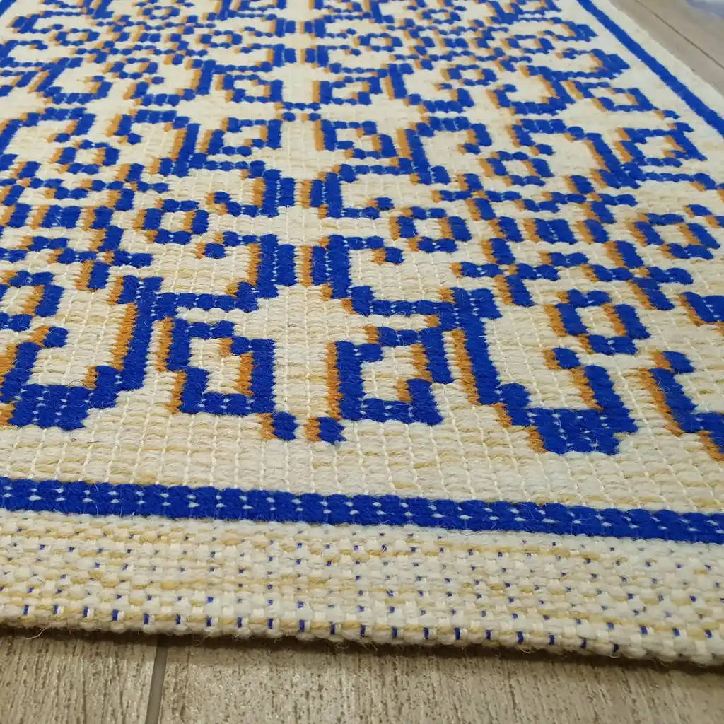 handwoven wool rug with traditional weaving pattern.