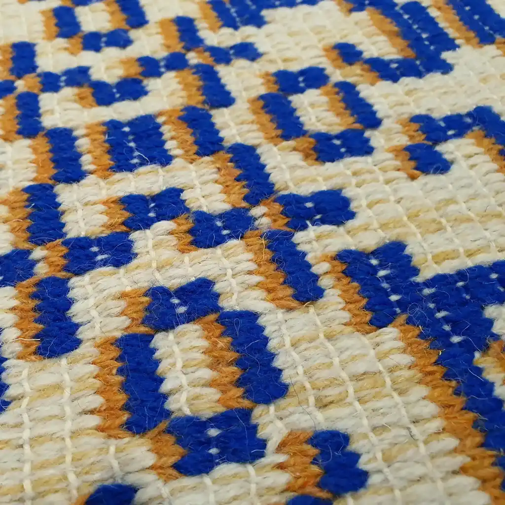 handwoven wool rug with traditional weaving pattern.