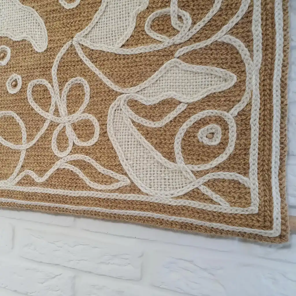 handmade cross-stitch wall hanging tapestry made from wool and jute materials.