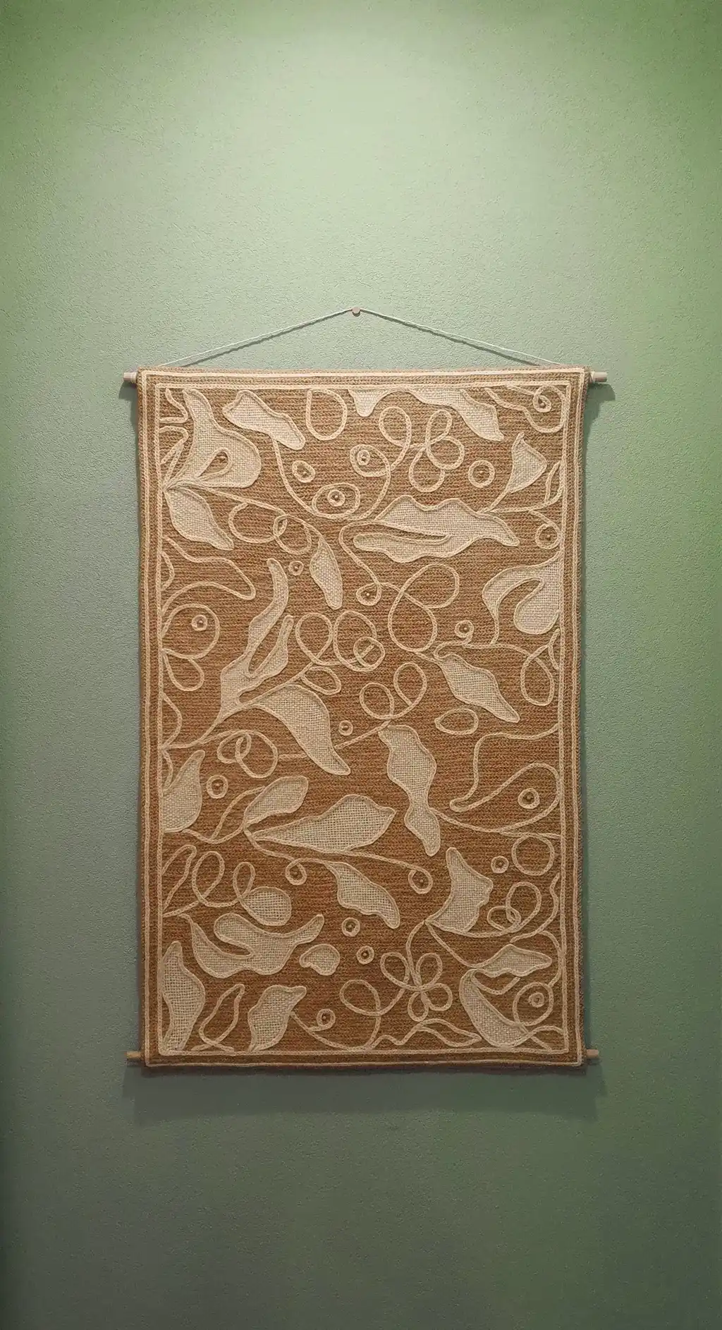 handmade cross-stitch wall hanging tapestry made from wool and jute materials.