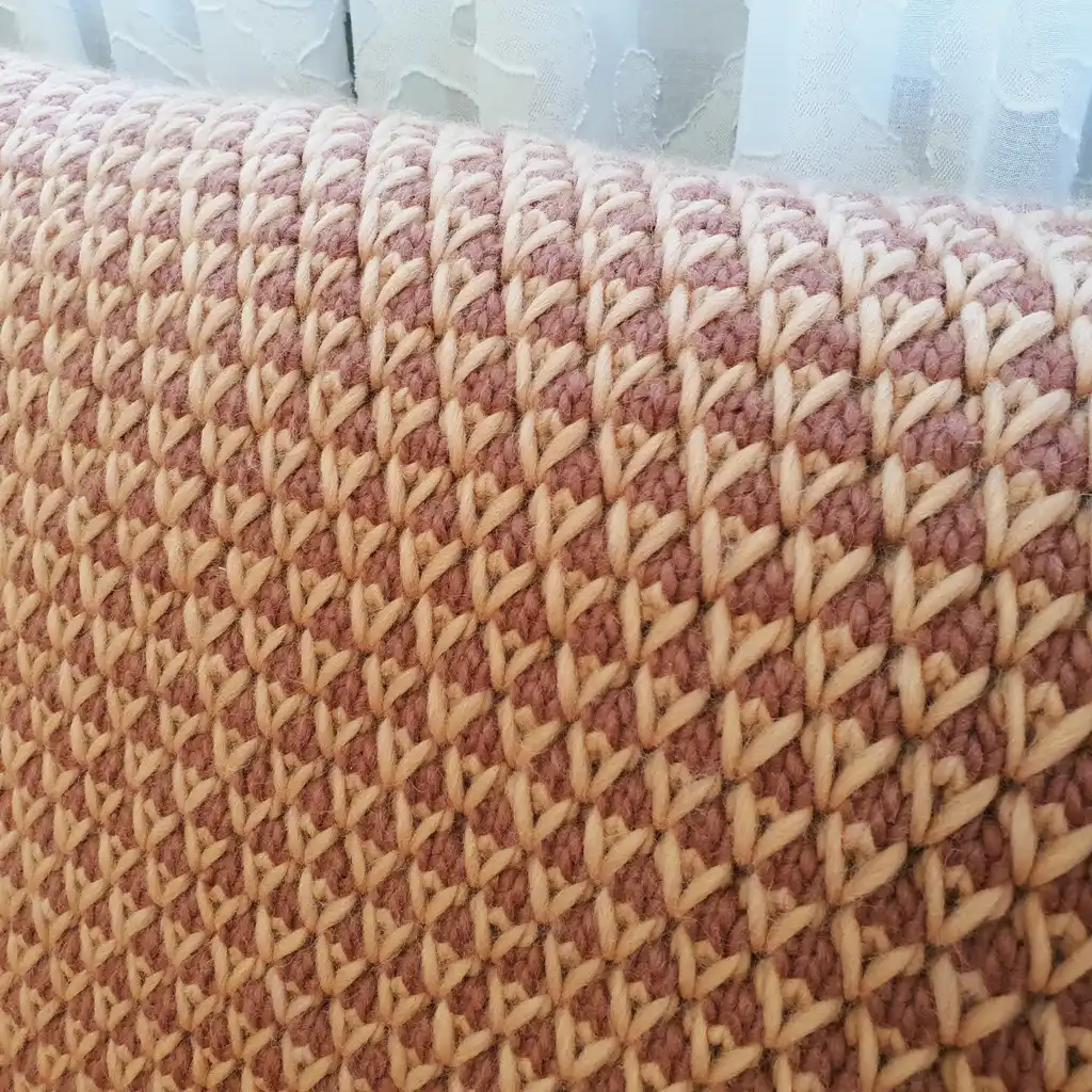 The luxury merino wool knitted throw blanket in elegant design.
