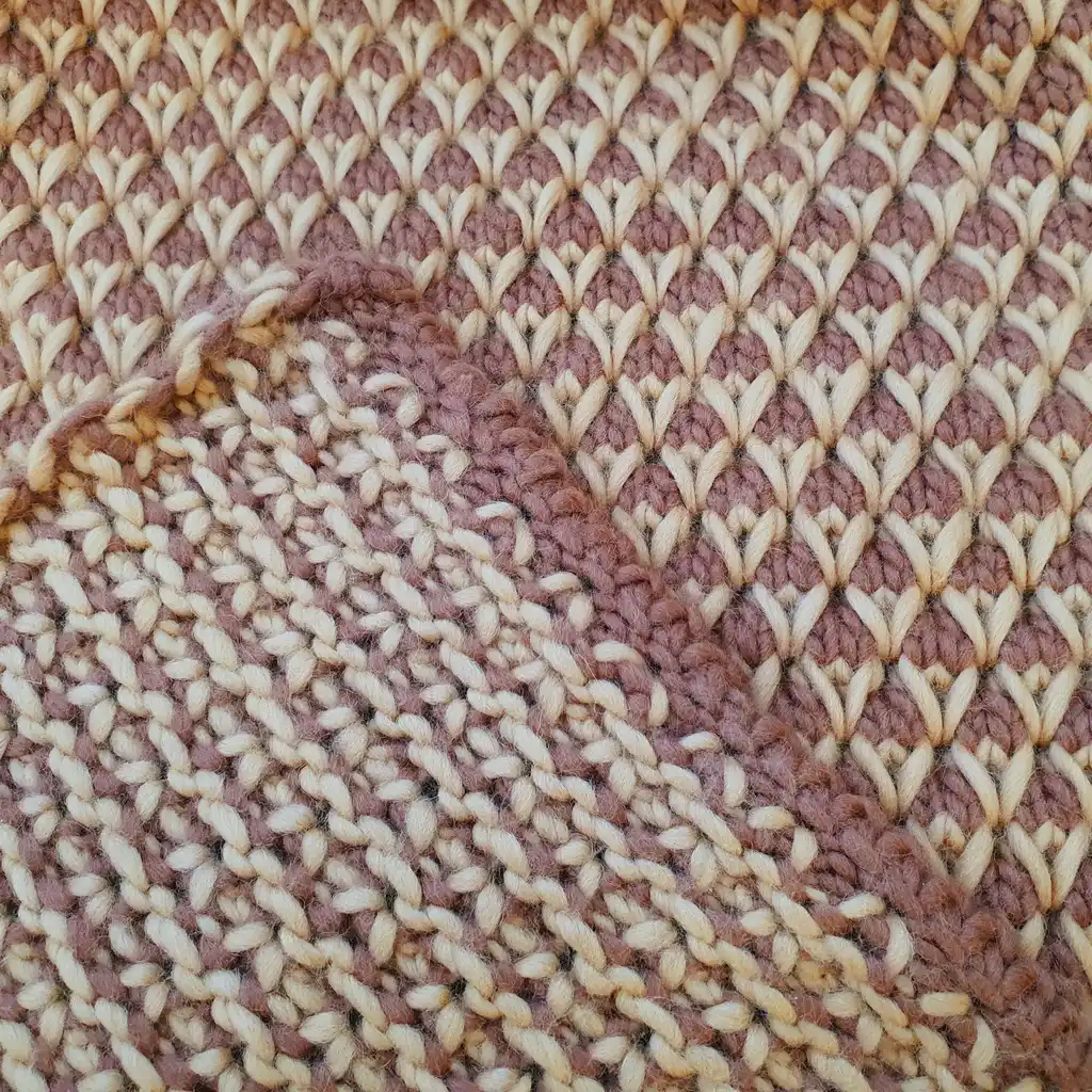 The luxury merino wool knitted throw blanket in elegant design.