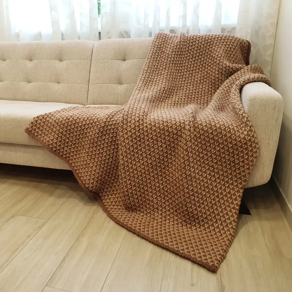 The luxury merino wool knitted throw blanket in elegant design.