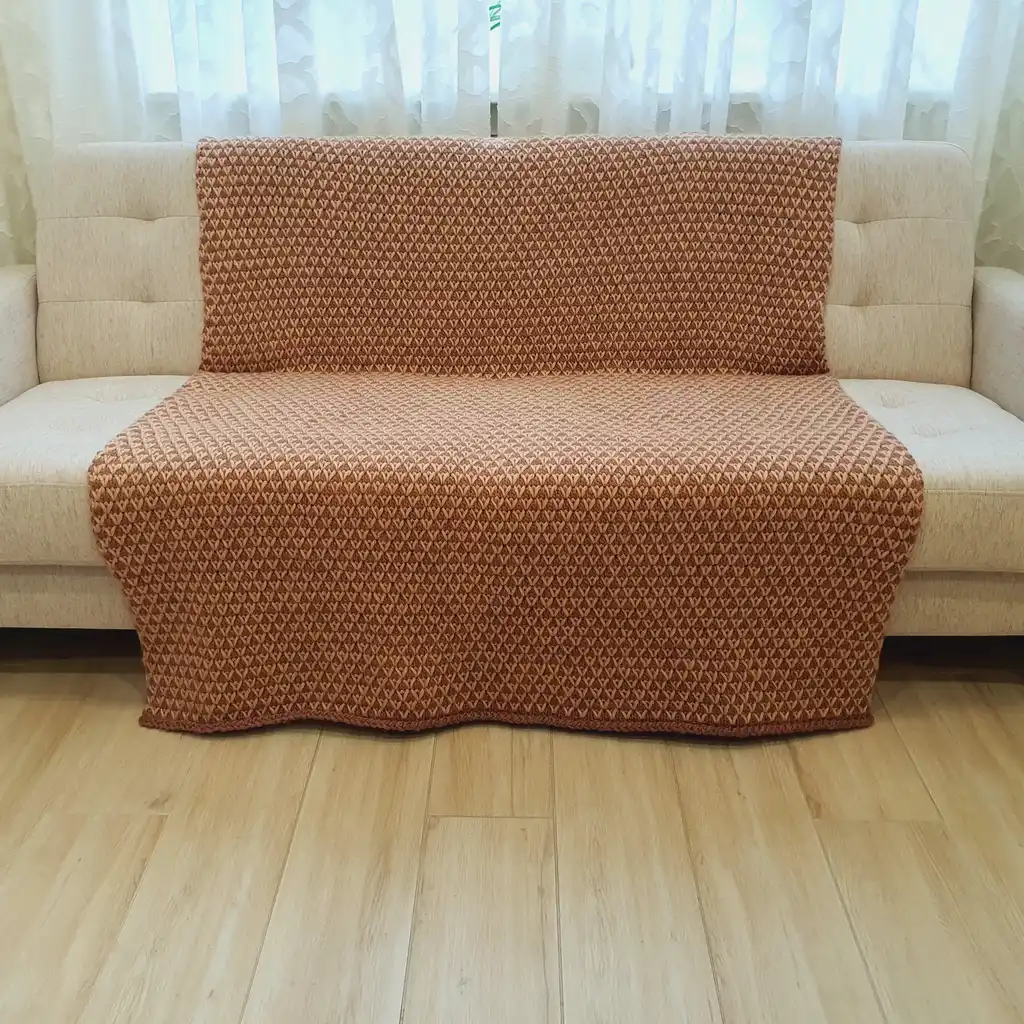 The luxury merino wool knitted throw blanket in elegant design.
