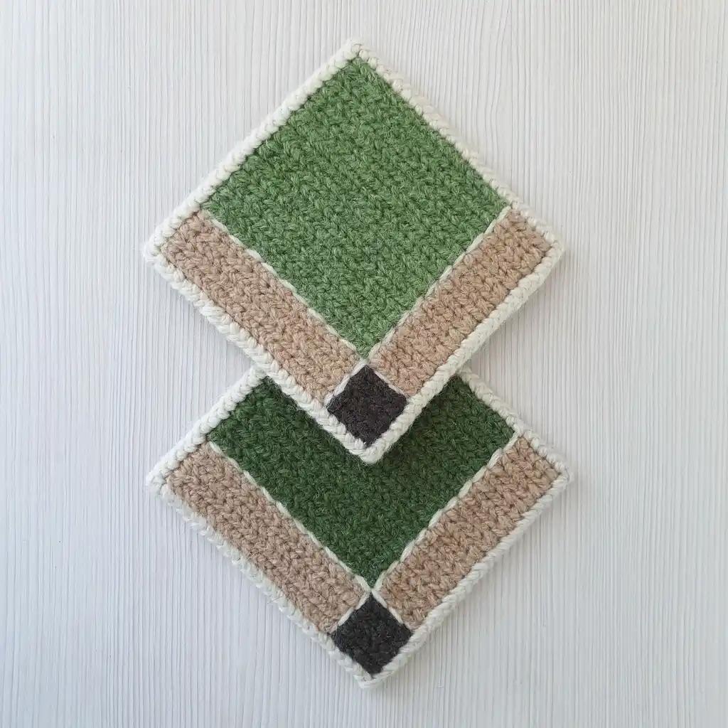 Handmade set of 4 cup coasters made of wool and jute with non-skid backing.