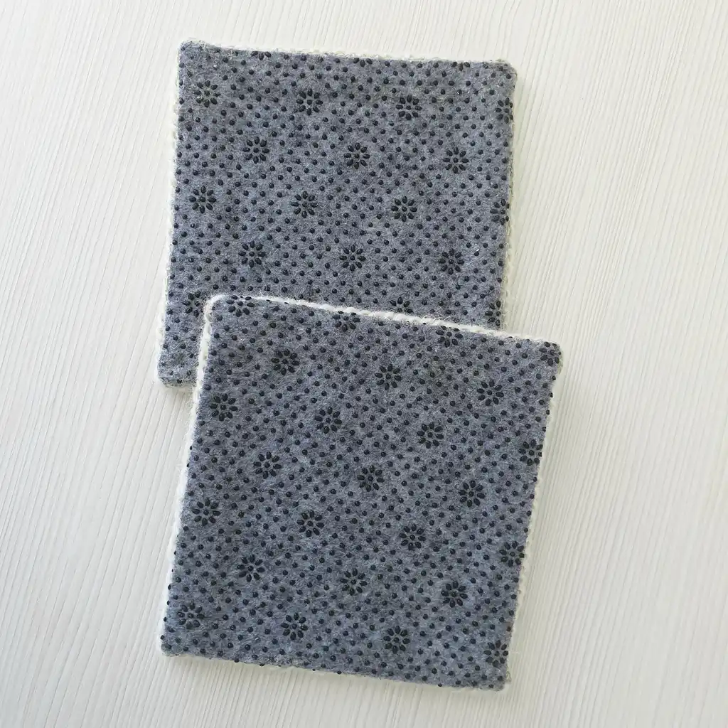 Handmade set of 4 mug pads made of wool and jute with non-skid backing.