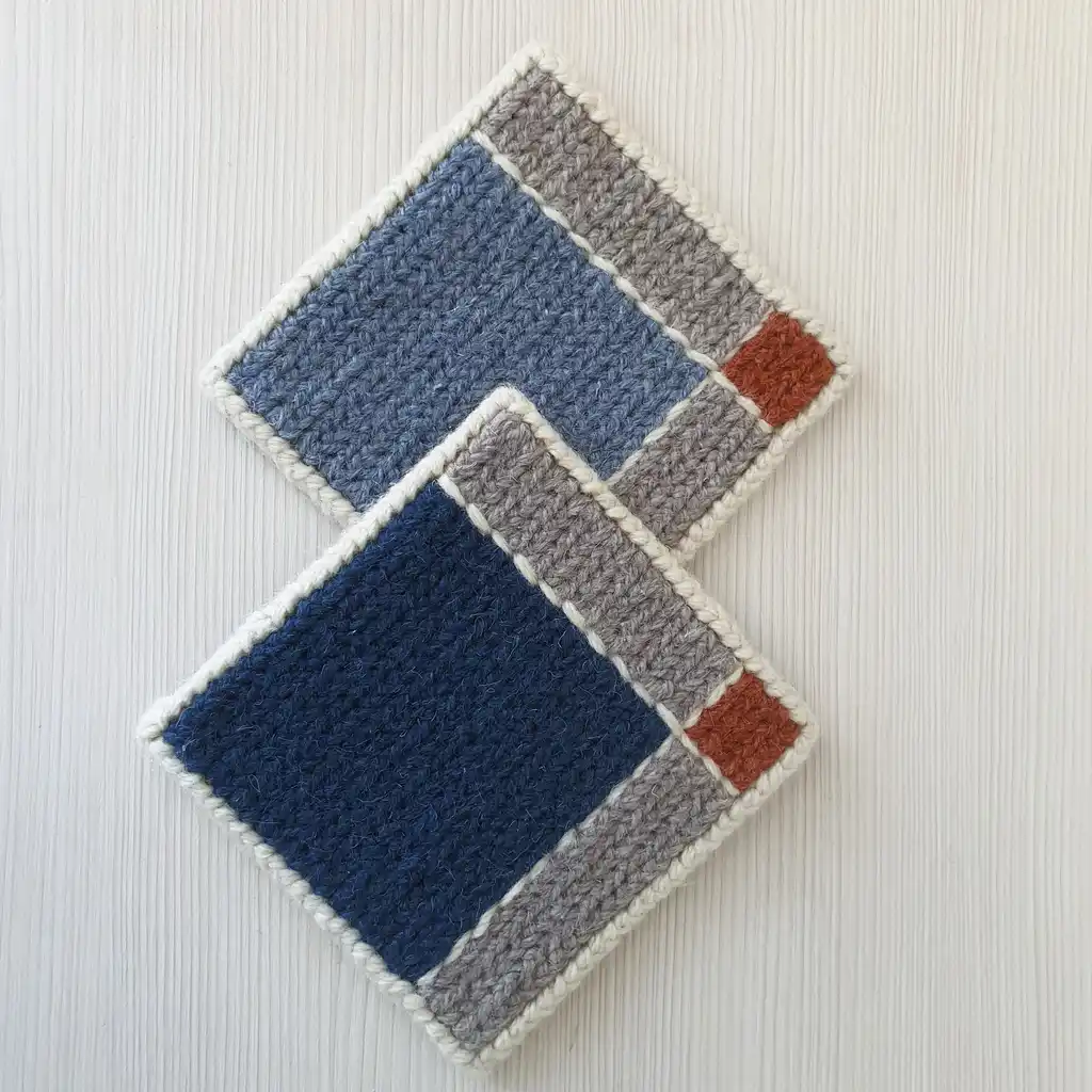 Handmade set of 4 cup coasters made of wool and jute with non-skid backing.