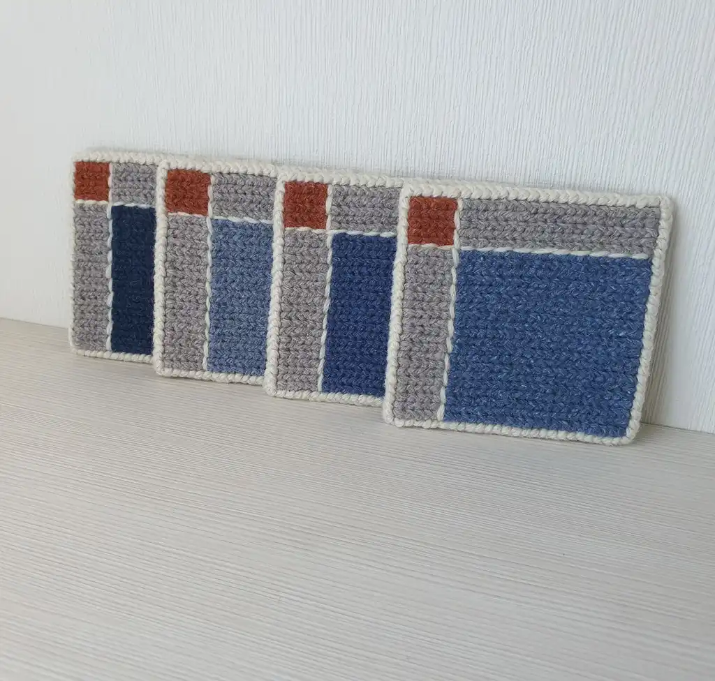 Handmade set of 4 mug pads made of wool and jute with non-skid backing.