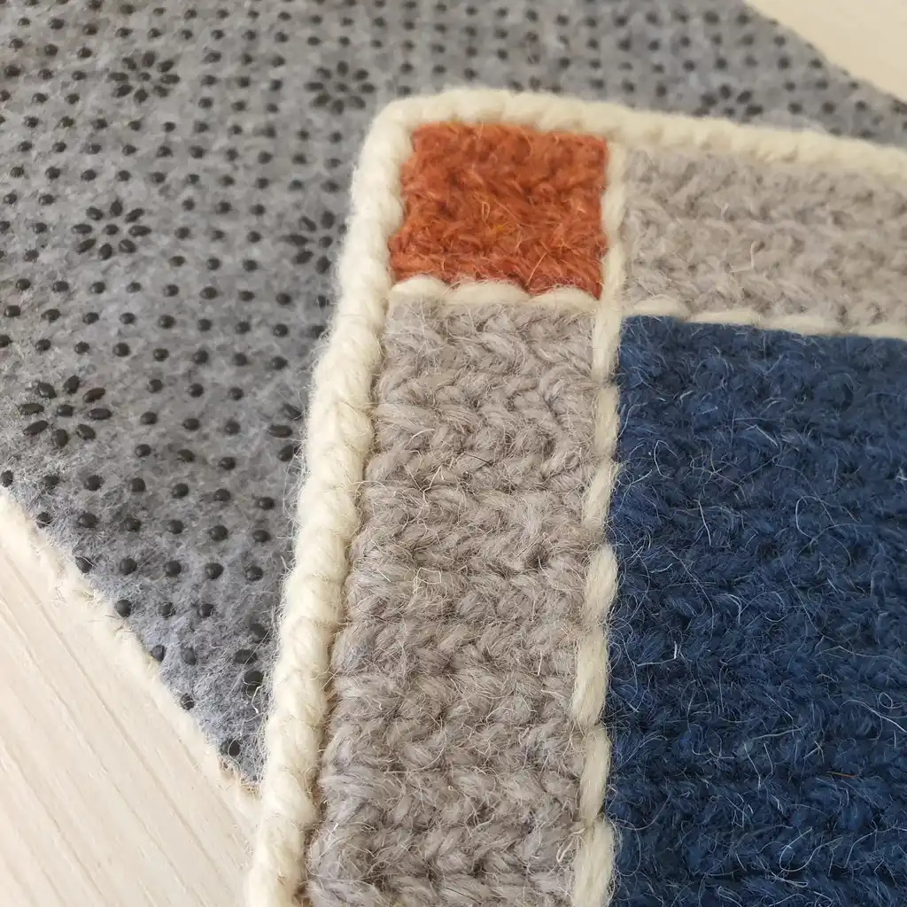 Handmade set of 4 mug pads made of wool and jute with non-skid backing.