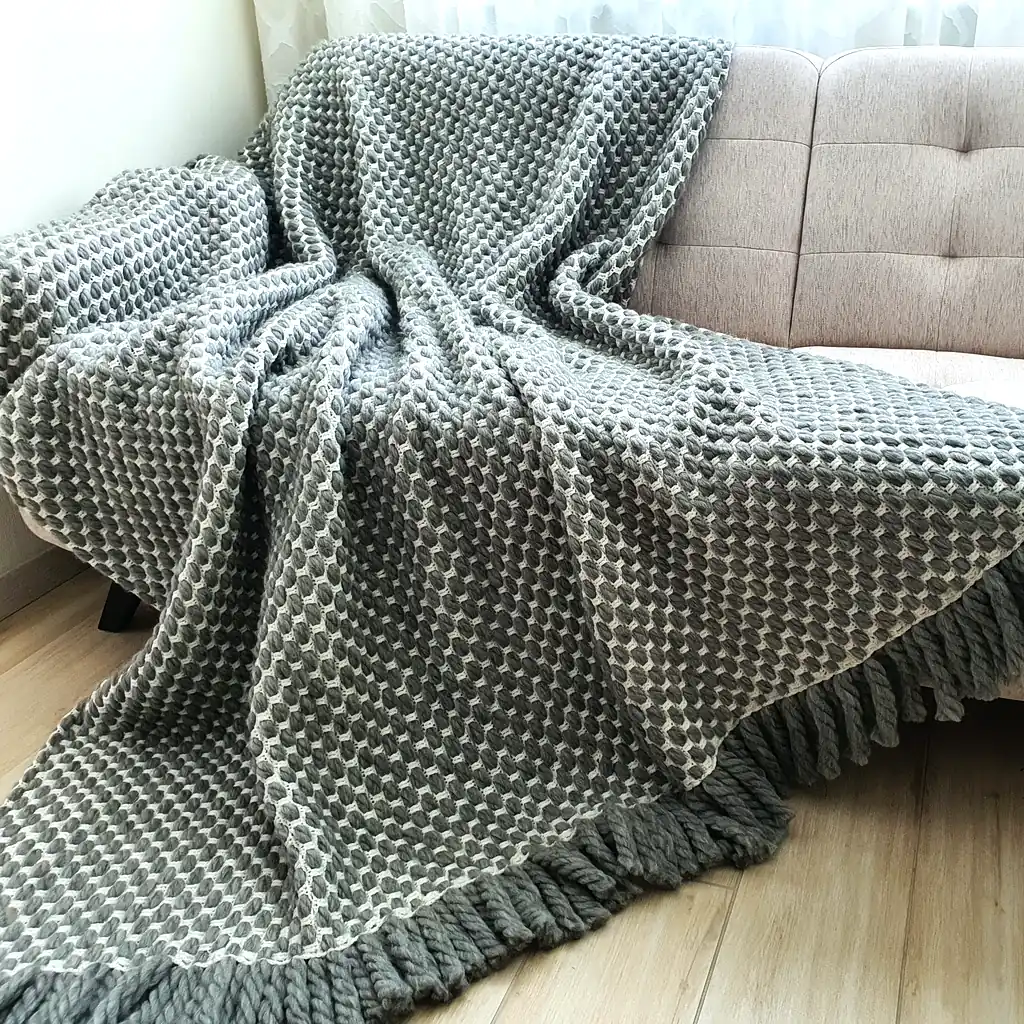 Handmade crocheted gray and white textured wool throw blanket with fringe, double-sided pattern