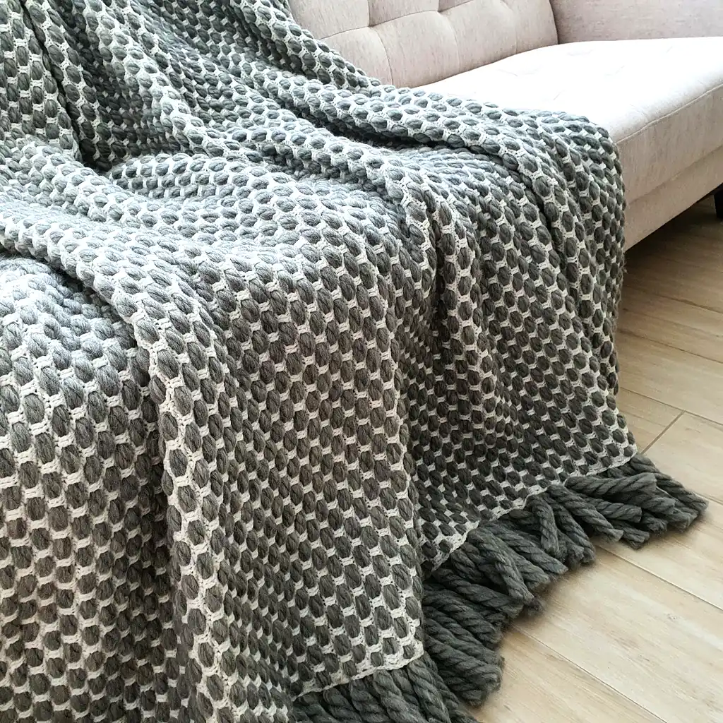 Handmade crocheted gray and white textured wool throw blanket with fringe, double-sided pattern