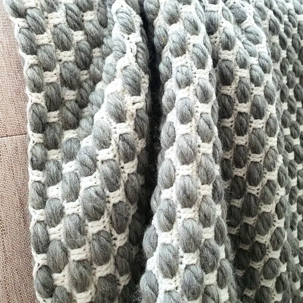 Handmade crocheted gray and white textured wool throw blanket with fringe, double-sided pattern