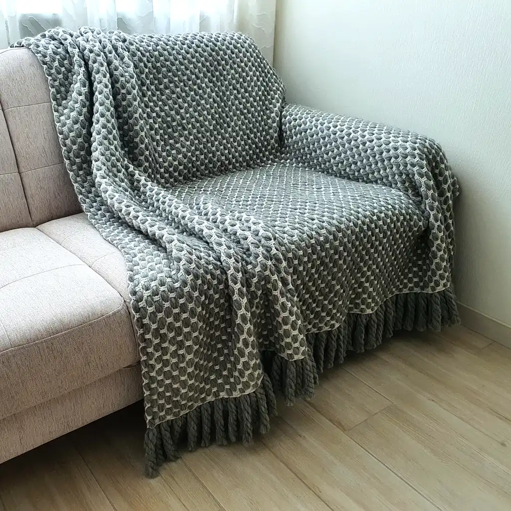Handmade crocheted gray and white textured wool throw blanket with fringe, double-sided pattern