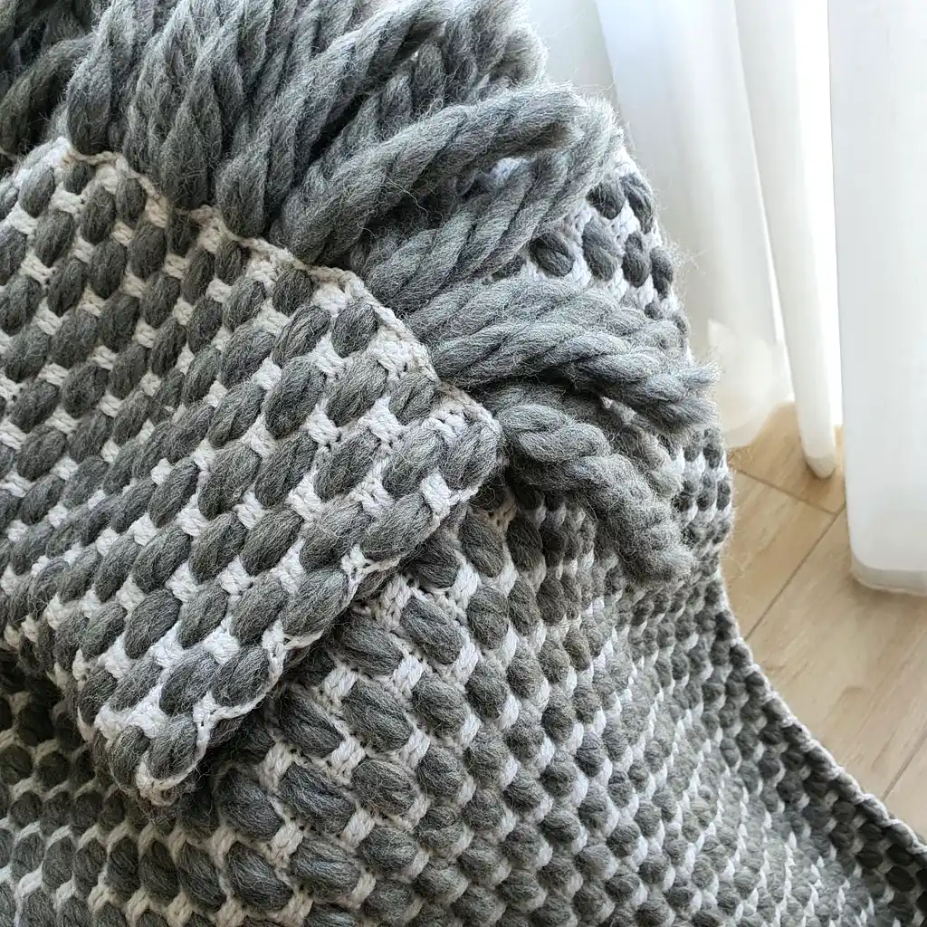 Handmade crocheted gray and white textured wool throw blanket with fringe, double-sided pattern