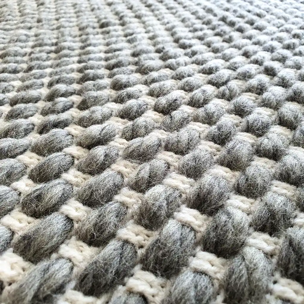 Handmade crocheted gray and white textured wool throw blanket with fringe, double-sided pattern