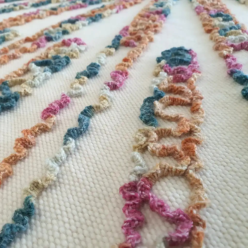 Handmade wool blanket with colorful, textured pattern and soft fleece lining.