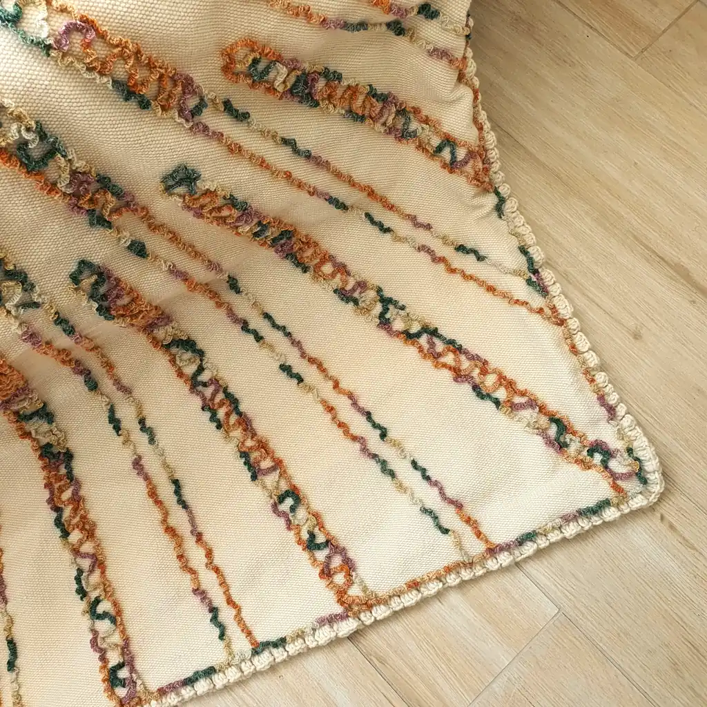 Close-up showing soft plush underside and detailed crochet edging..