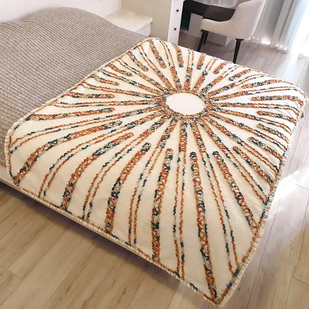 Wool throw with raised embroidered sunburst design, handwoven in Ukraine.