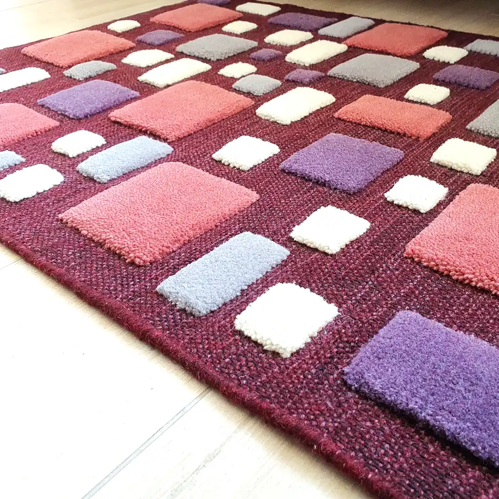 Cozy bedroom decor featuring a deep burgundy handwoven wool rug. Sustainable home accent that adds warmth and artistic character to a Scandi or Boho room.