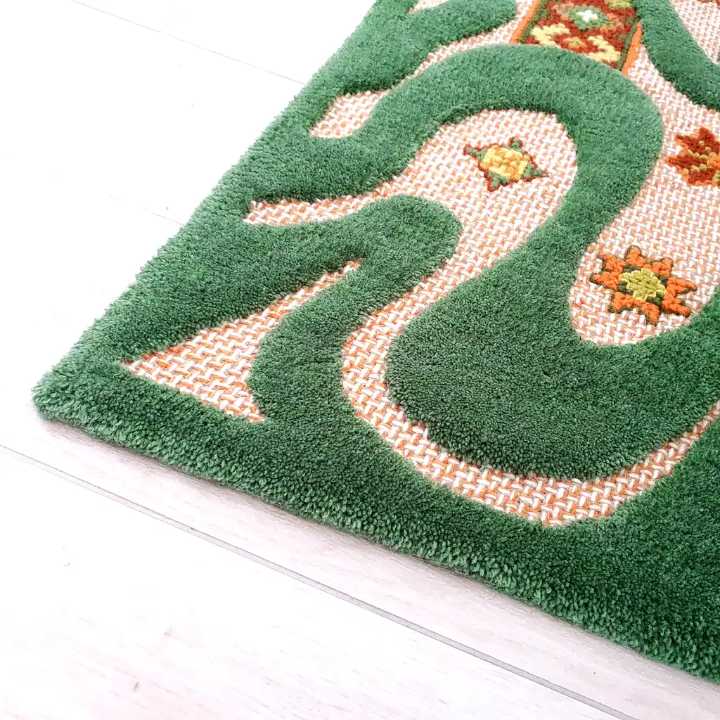 Folk elements: Small embroidered flower-like stars in orange and yellow wool.