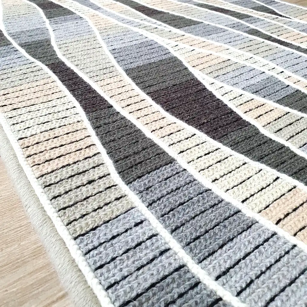 Handmade cross-stitch wool rug with wavy gray and beige stripes, thick plush lining, perfect for living room or bedroom