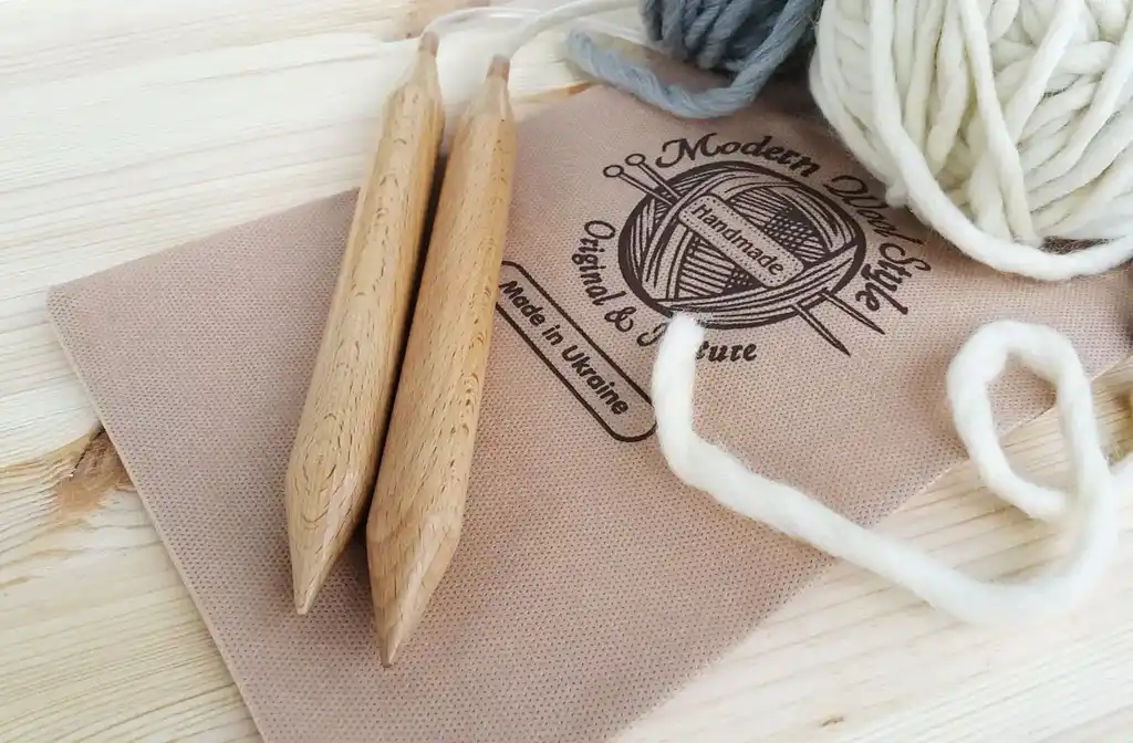 premium beech wood knitting needles 20mm diameter on white background.