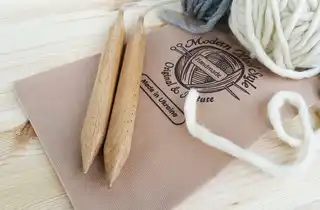 premium beech wood knitting needles 20mm diameter on white background.