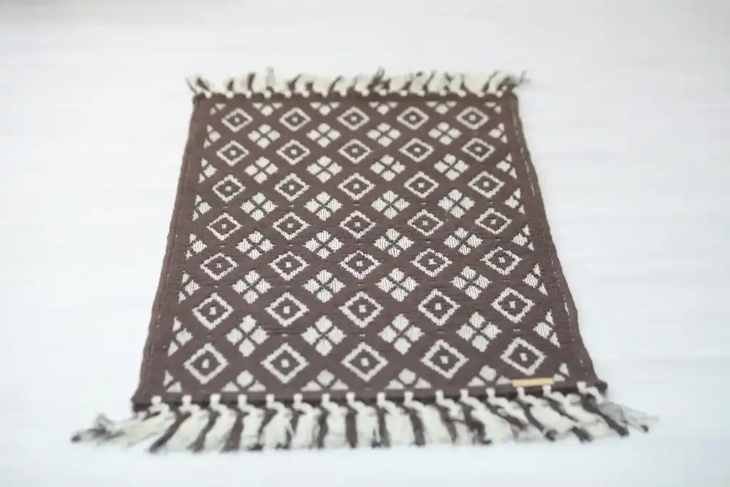 handwoven wool rug featuring traditional weaving technique and natural wool texture.