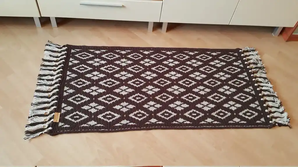 handwoven wool rug featuring traditional weaving technique and natural wool texture.