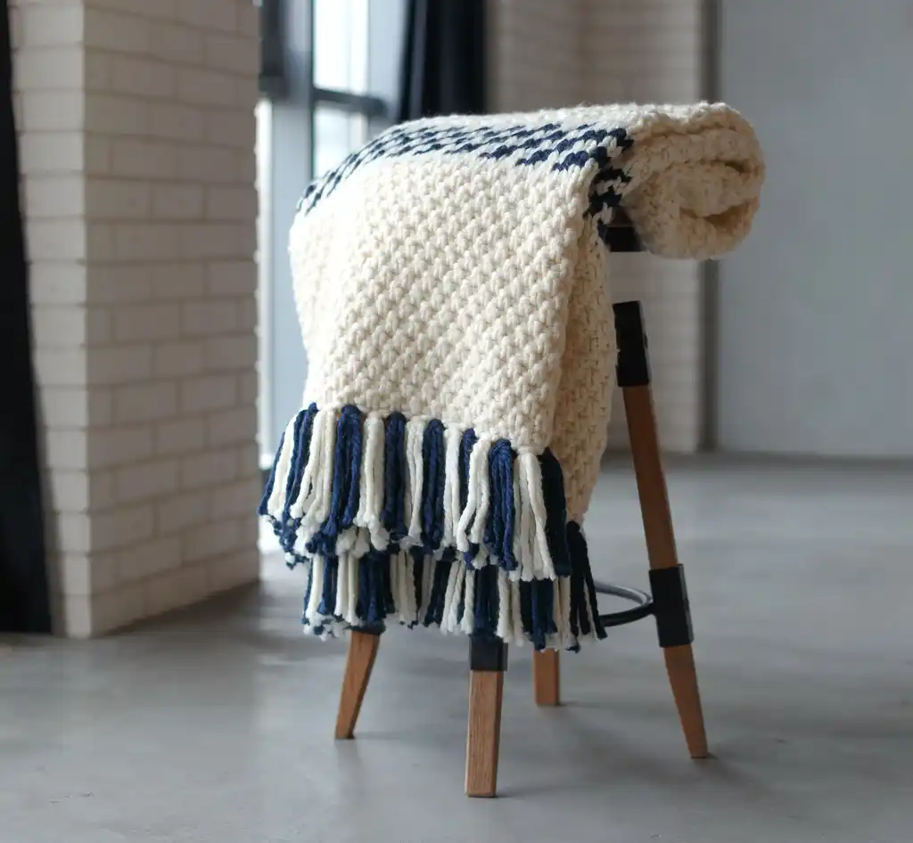 knitted blended wool throw blanket in natural color.