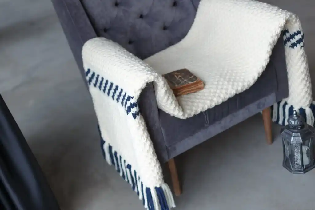 knitted blended wool throw blanket in natural color.
