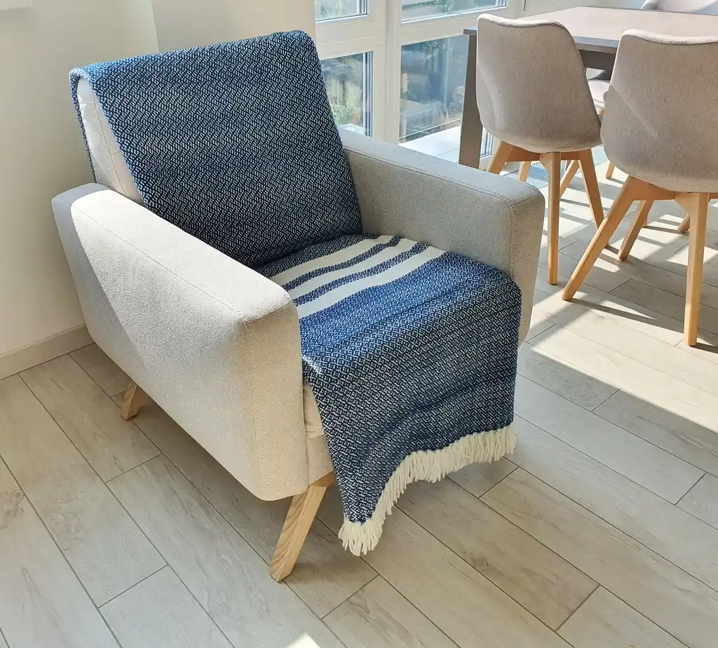 premium merino wool woven throw blanket in neutral colors.