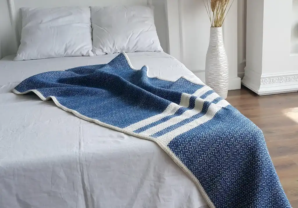 premium merino wool woven throw blanket in neutral colors.