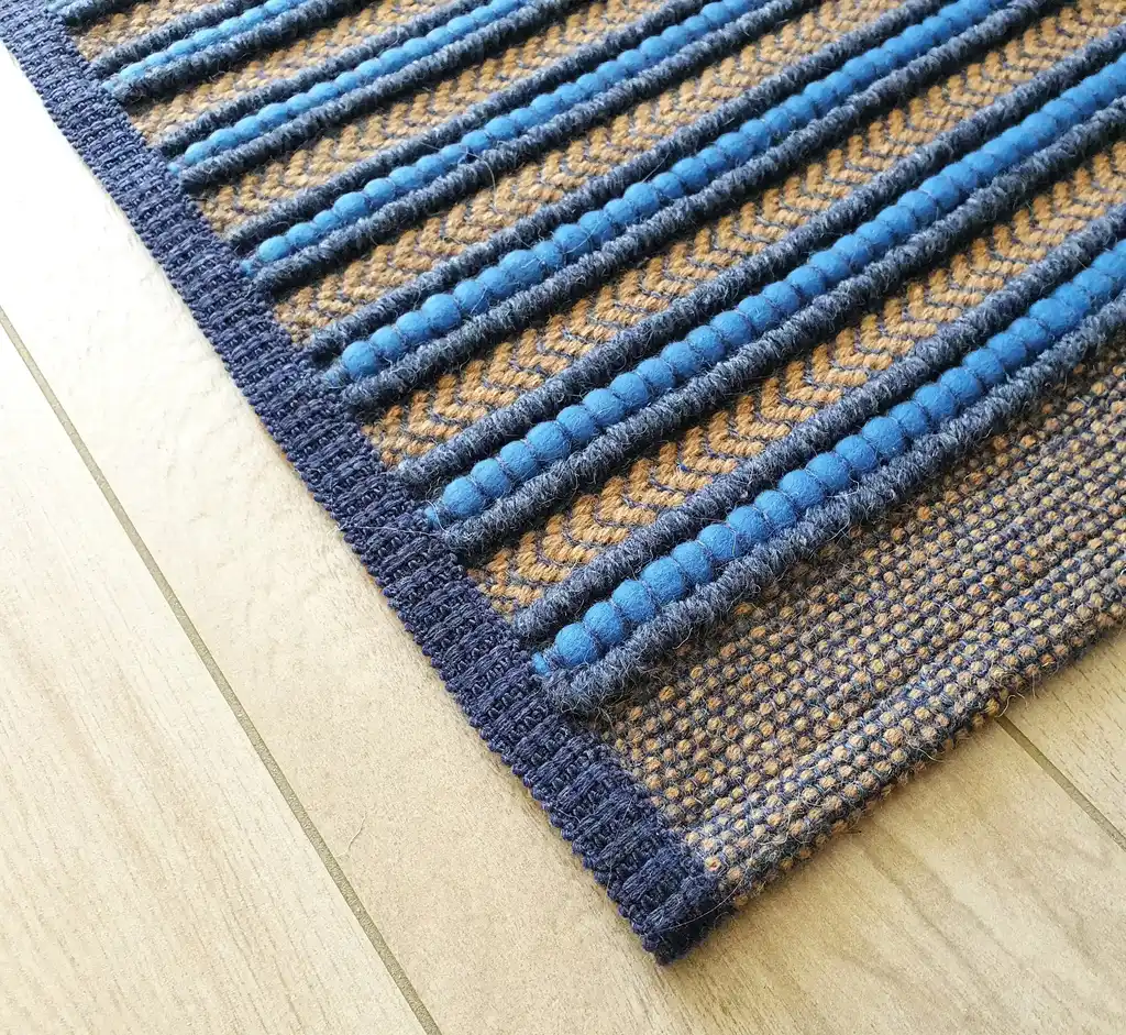 handwoven rug made from natural jute and chunky wool fibers.