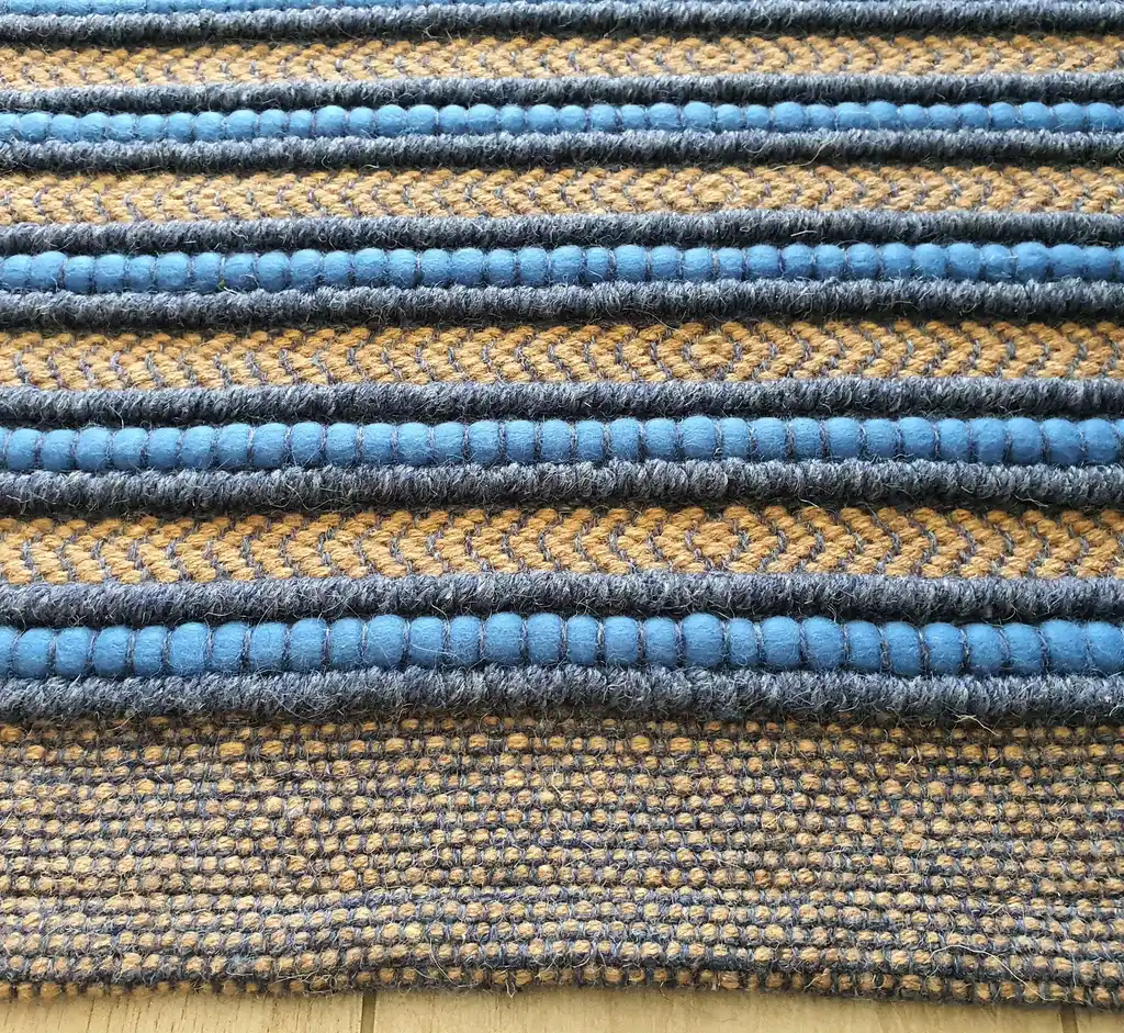 handwoven rug made from natural jute and chunky wool fibers.
