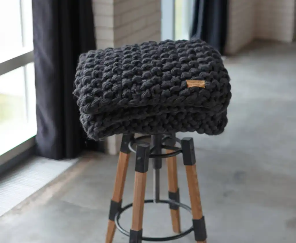 chunky wool knit blanket in natural tones, handcrafted traditional knitting.
