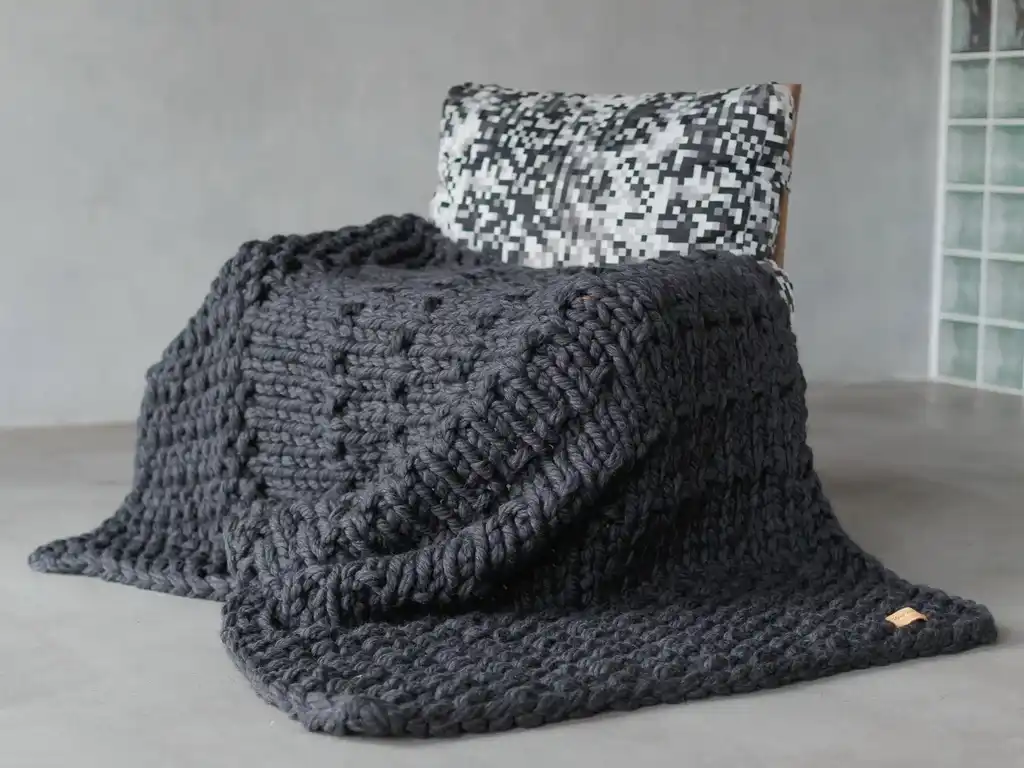 chunky wool knit blanket in natural tones, handcrafted traditional knitting.