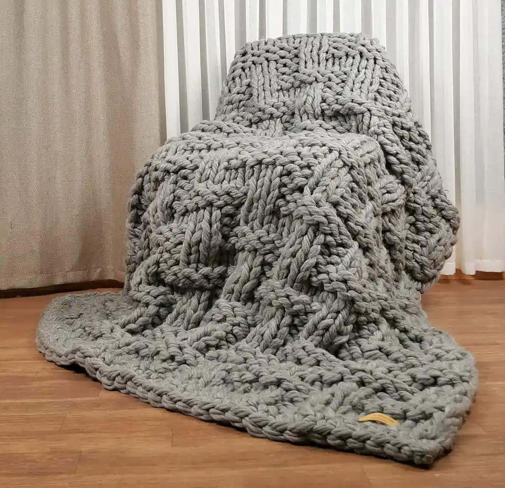 chunky wool knitted blanket in neutral tones, hand-crafted premium throw blanket.