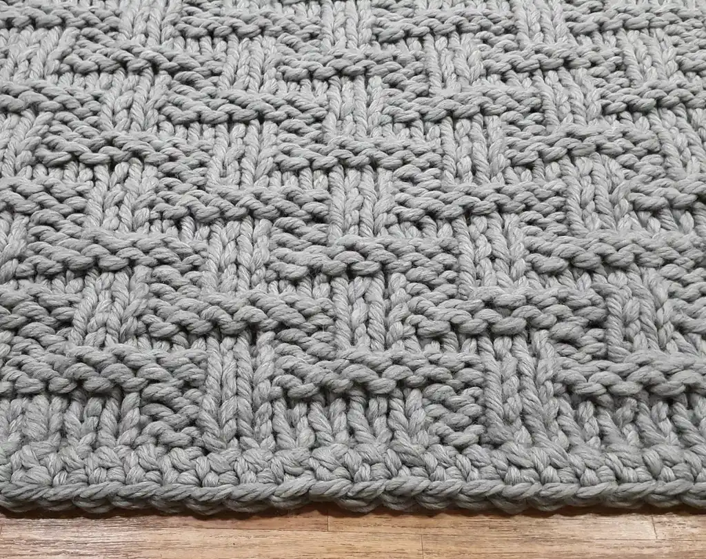 chunky wool knitted blanket in neutral tones, hand-crafted premium throw blanket.