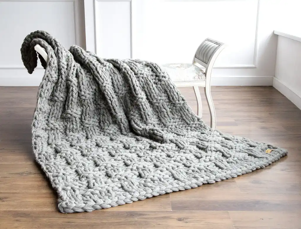 chunky wool knitted blanket in neutral tones, hand-crafted premium throw blanket.