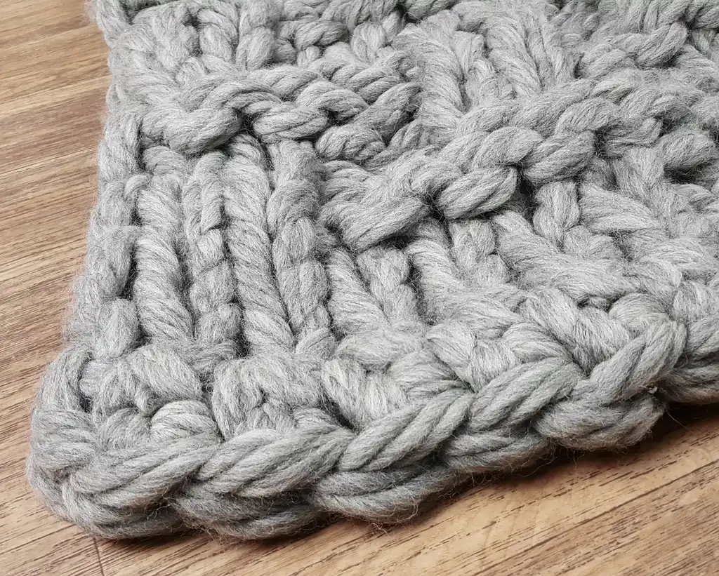 chunky wool knitted blanket in neutral tones, hand-crafted premium throw blanket.