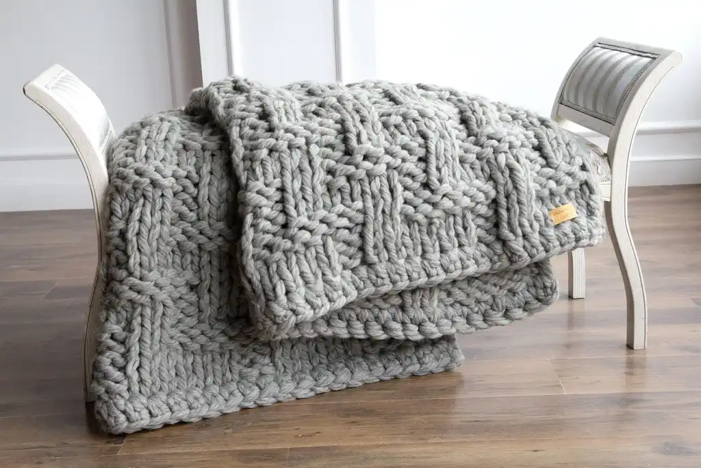 chunky wool knitted blanket in neutral tones, hand-crafted premium throw blanket.