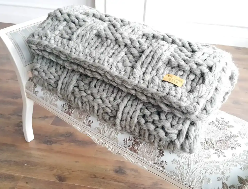 chunky wool knitted blanket in neutral tones, hand-crafted premium throw blanket.