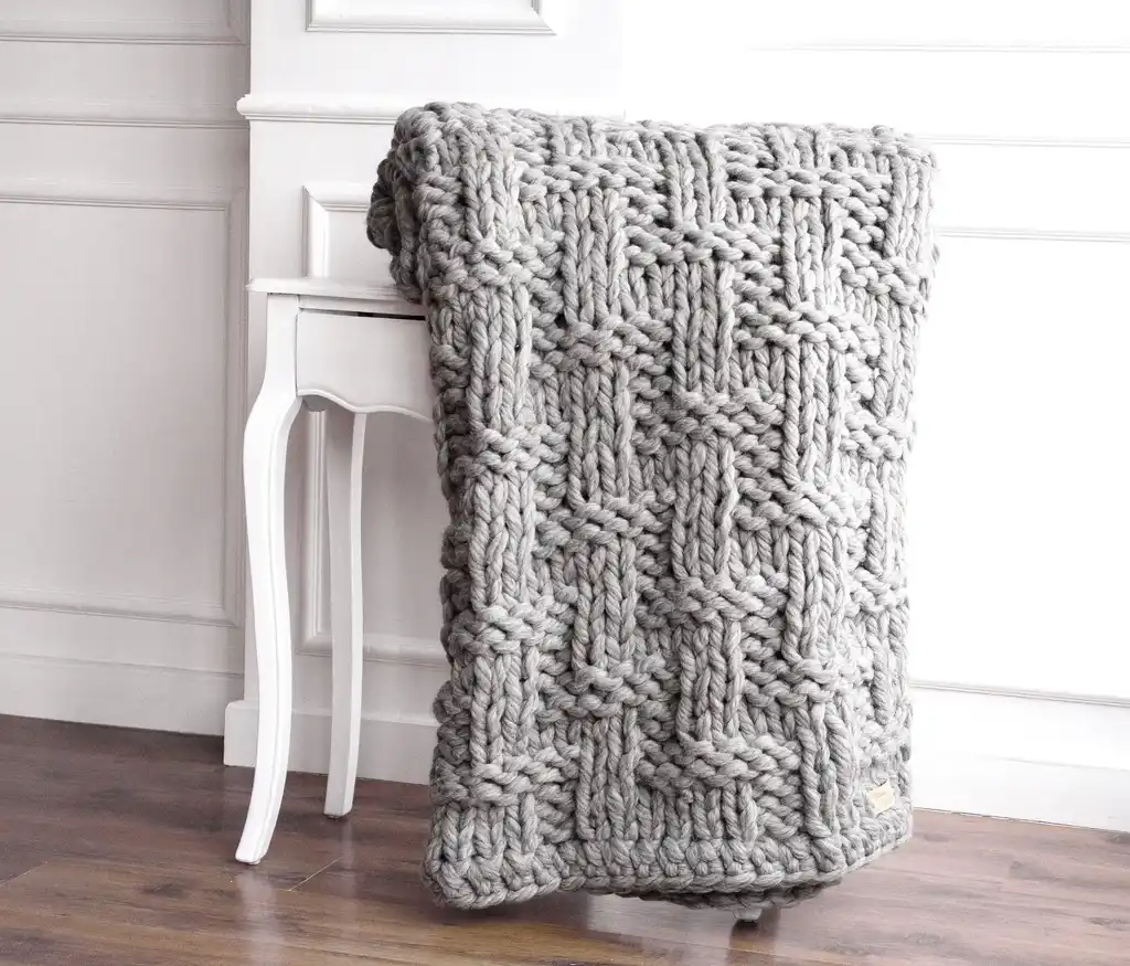 chunky wool knitted blanket in neutral tones, hand-crafted premium throw blanket.
