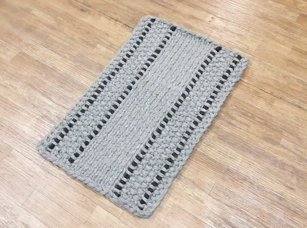handmade chunky wool knitted rug in natural texture.