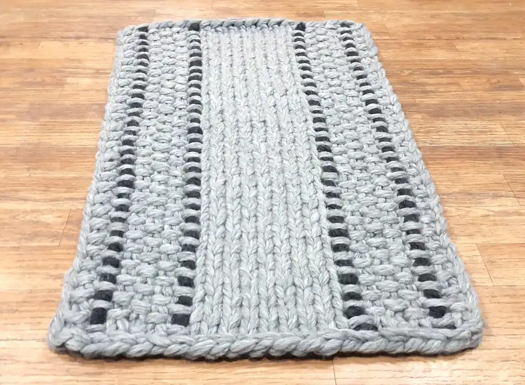 handmade chunky wool knitted rug in natural texture.