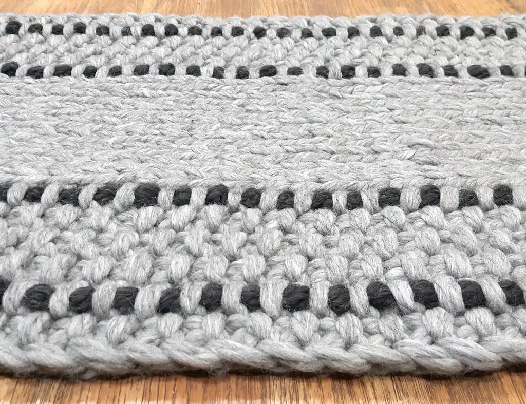 handmade chunky wool knitted rug in natural texture.