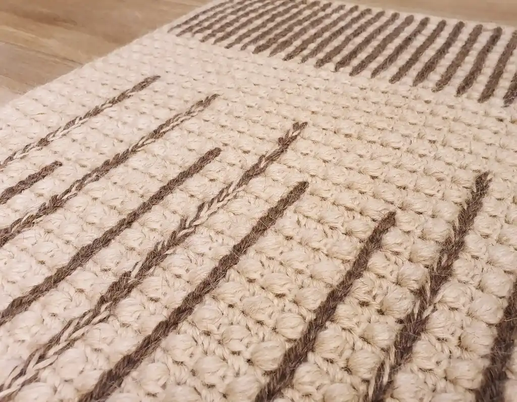 handmade crochet wool rug in neutral tones, showcasing artisan craftsmanship and premium quality materials.