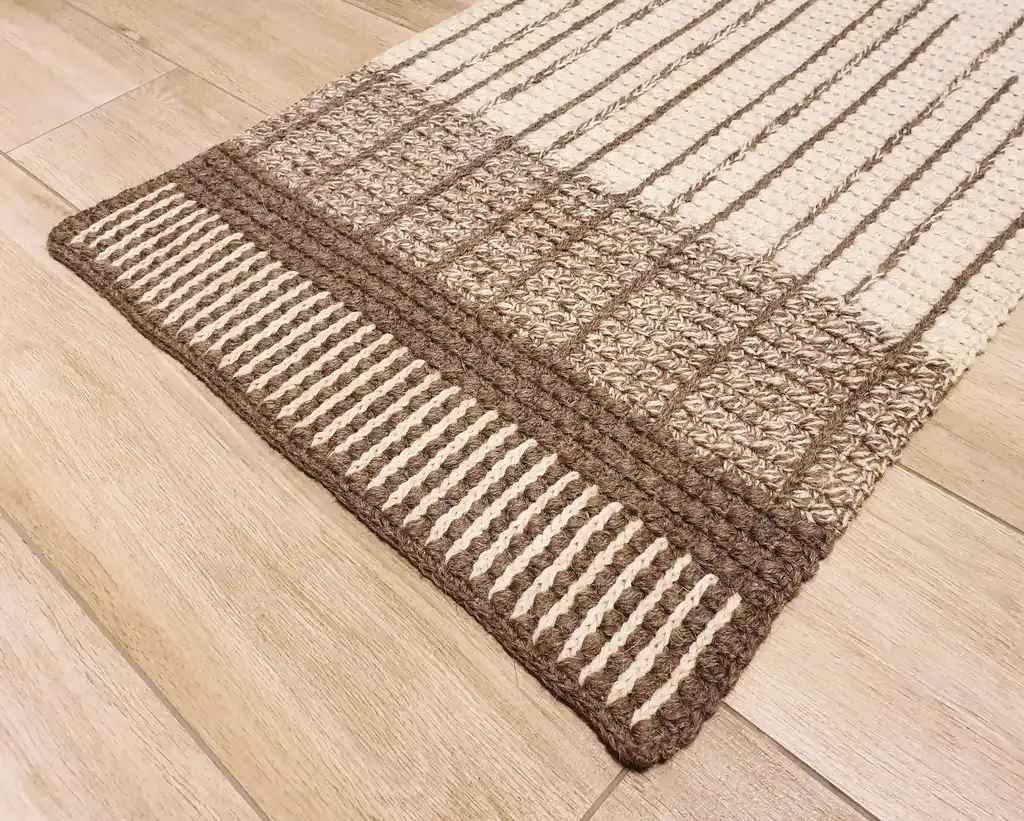 handmade crochet wool rug in neutral tones, showcasing artisan craftsmanship and premium quality materials.