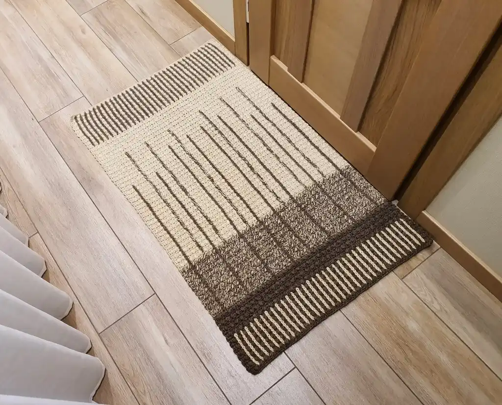 handmade crochet wool rug in neutral tones, showcasing artisan craftsmanship and premium quality materials.